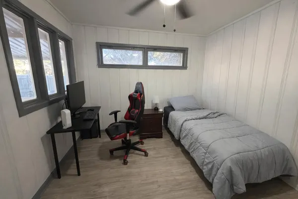 a bed room with a bed and a chair
