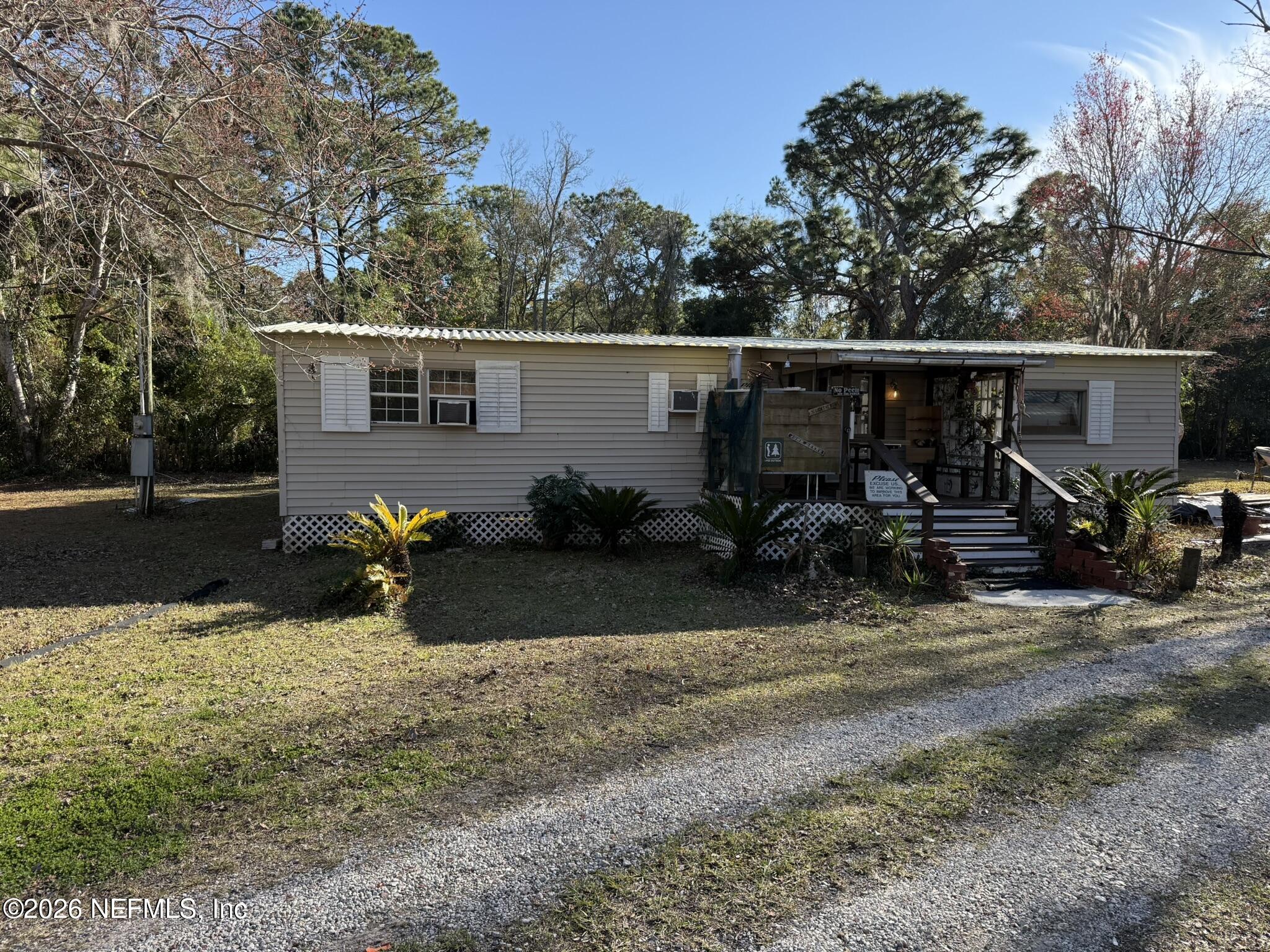 95291 Alligator Creek Road Fernandina Beach, FL 32034 - Photo 23 of 27 a backyard of a house with table and chairs