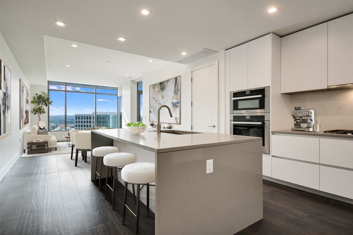 501 West Avenue, Unit 1802 Austin, TX 78701 - Photo 1 of 35 a living room with stainless steel appliances furniture cabinets and a wooden floor