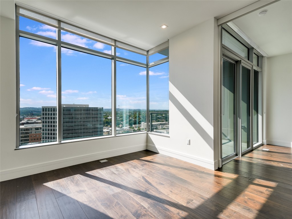 501 West Avenue, Unit 1802 Austin, TX 78701 - Photo 7 of 35 a view of an empty room with wooden floor and a window
