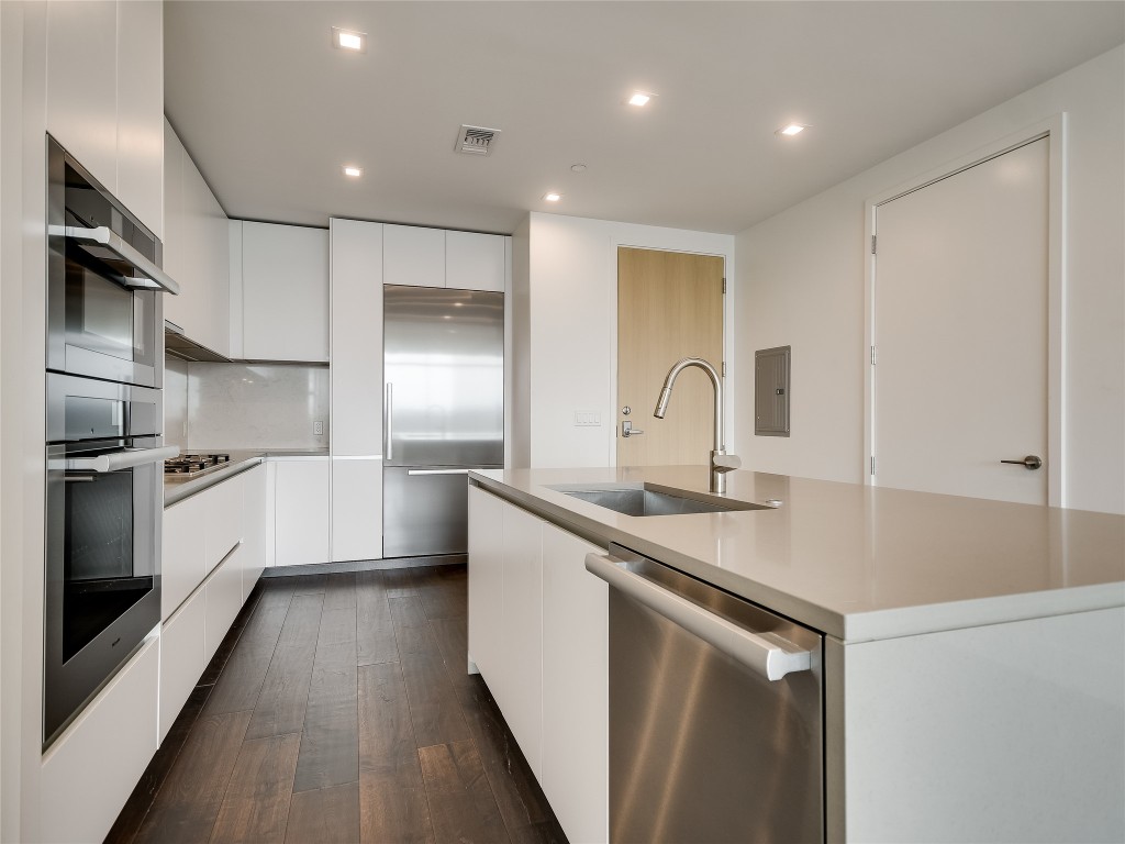 501 West Avenue, Unit 1802 Austin, TX 78701 - Photo 9 of 35 a kitchen with a sink stainless steel appliances and white cabinets