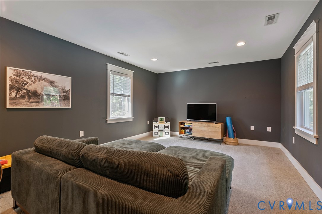 9749 Hoke Brady Road Henrico, VA 23231 - Photo 39 of 53 a bedroom with a bed and a flat screen tv