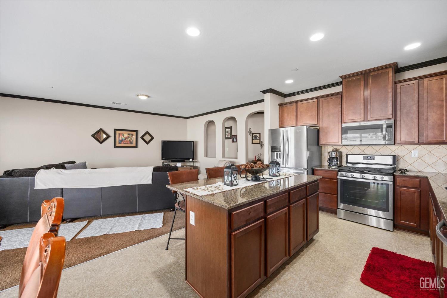 Undisclosed Address Bakersfield, CA 93313 - Photo 11 of 28 a kitchen with stainless steel appliances granite countertop a stove top oven a sink dishwasher and cabinets with wooden floor