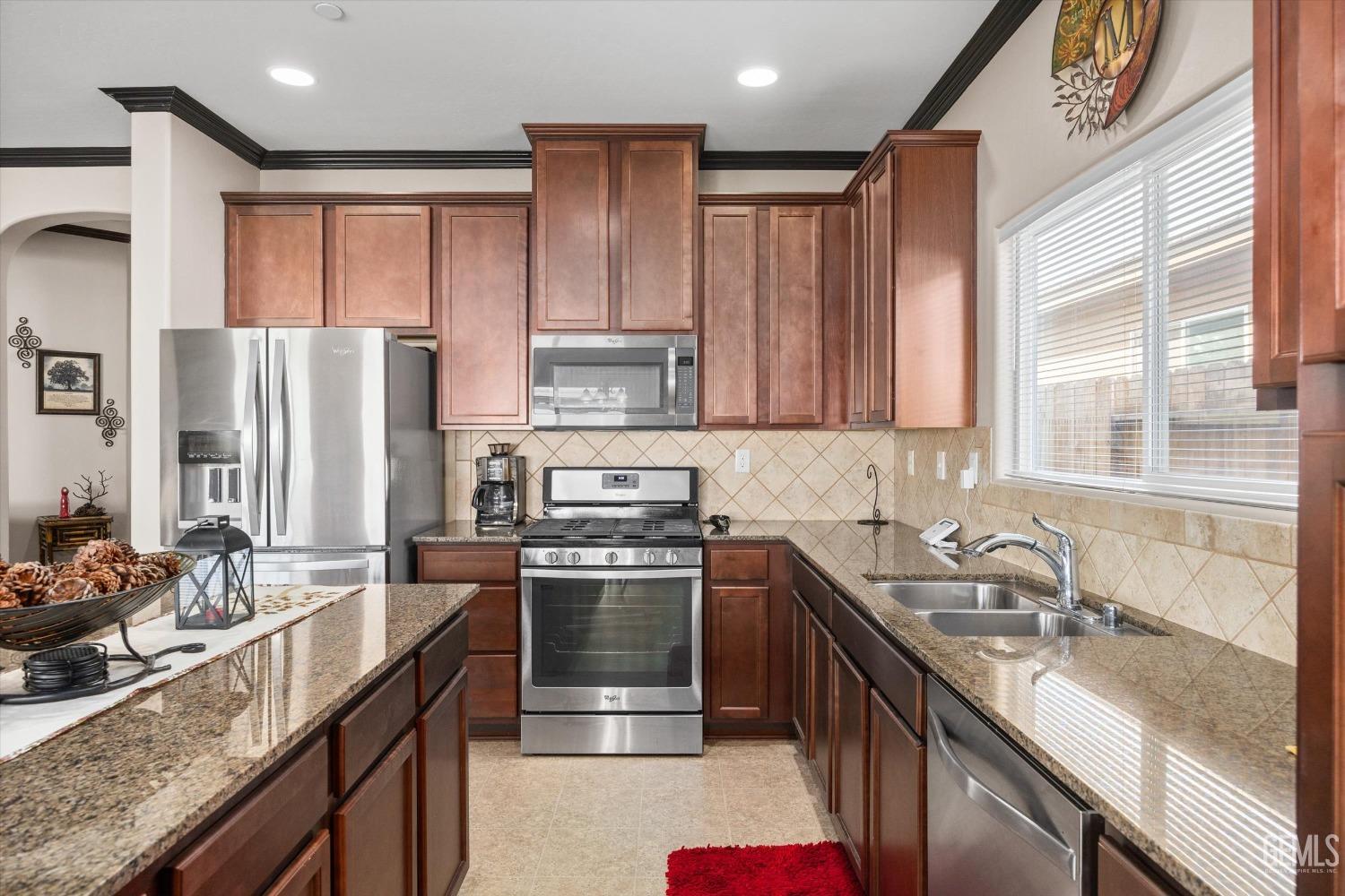Undisclosed Address Bakersfield, CA 93313 - Photo 12 of 28 a kitchen with stainless steel appliances granite countertop a sink stove refrigerator and cabinets