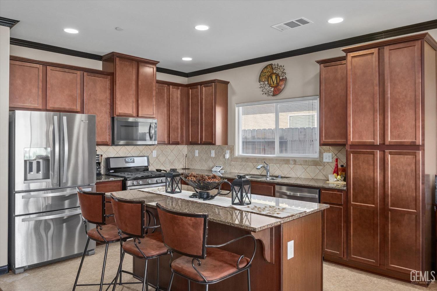 Undisclosed Address Bakersfield, CA 93313 - Photo 14 of 28 a kitchen with stainless steel appliances granite countertop a sink refrigerator and cabinets