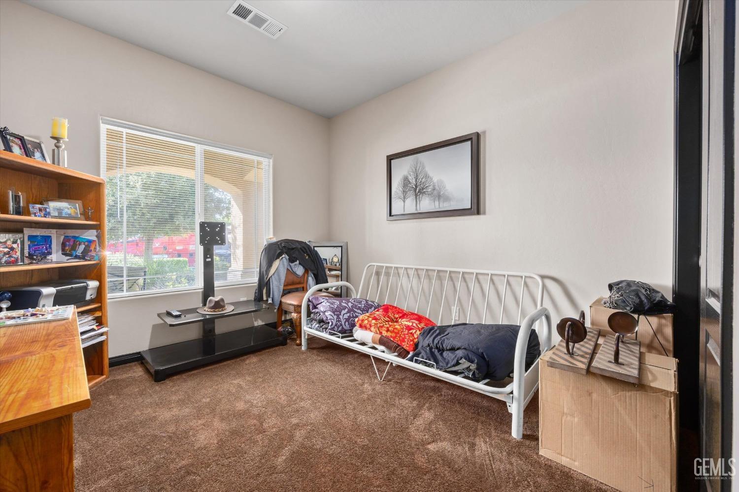 Undisclosed Address Bakersfield, CA 93313 - Photo 18 of 28 a bedroom with furniture and a flat screen tv