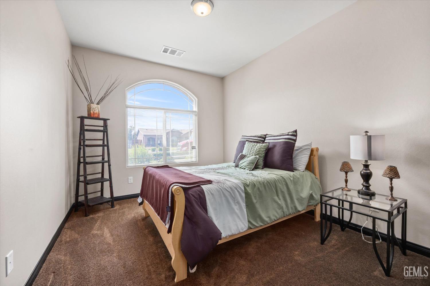 Undisclosed Address Bakersfield, CA 93313 - Photo 20 of 28 a bed room with a bed and a window