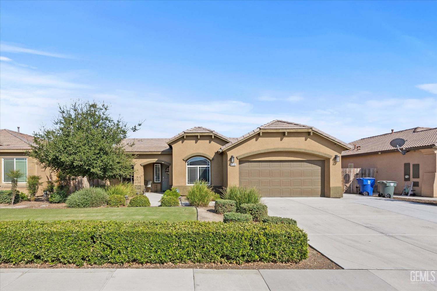 Undisclosed Address Bakersfield, CA 93313 - Photo 2 of 28 a front view of a house with a yard