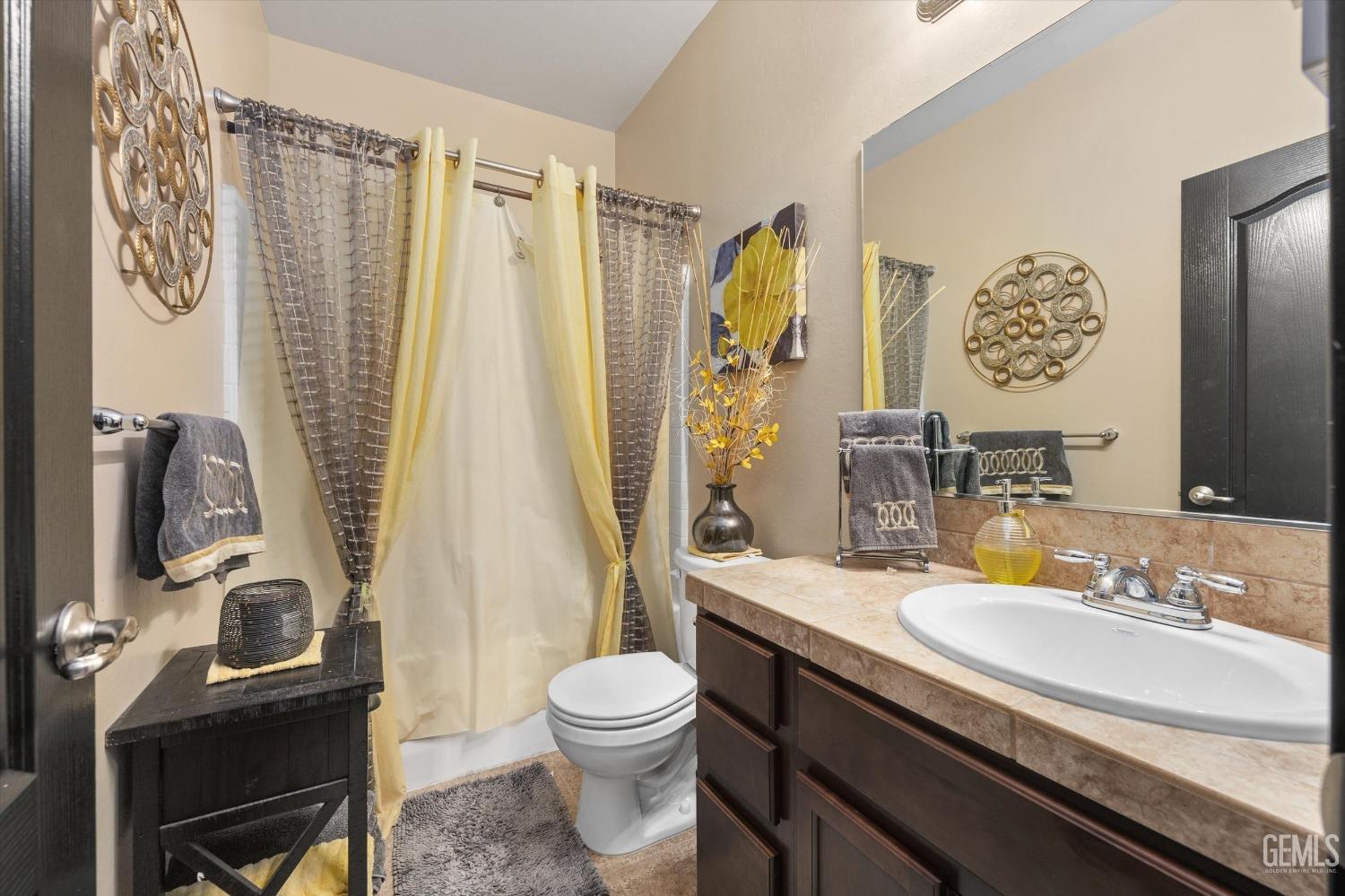 Undisclosed Address Bakersfield, CA 93313 - Photo 21 of 28 a bathroom with a granite countertop sink toilet and shower