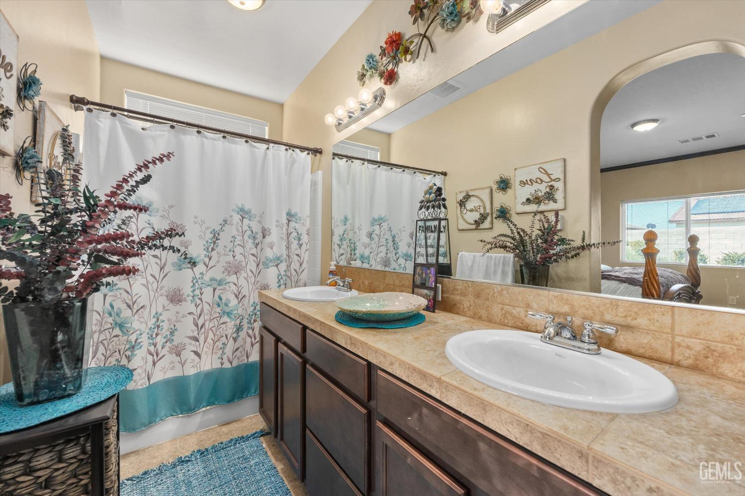 Undisclosed Address Bakersfield, CA 93313 - Photo 23 of 28 a bathroom with a granite countertop sink and a mirror