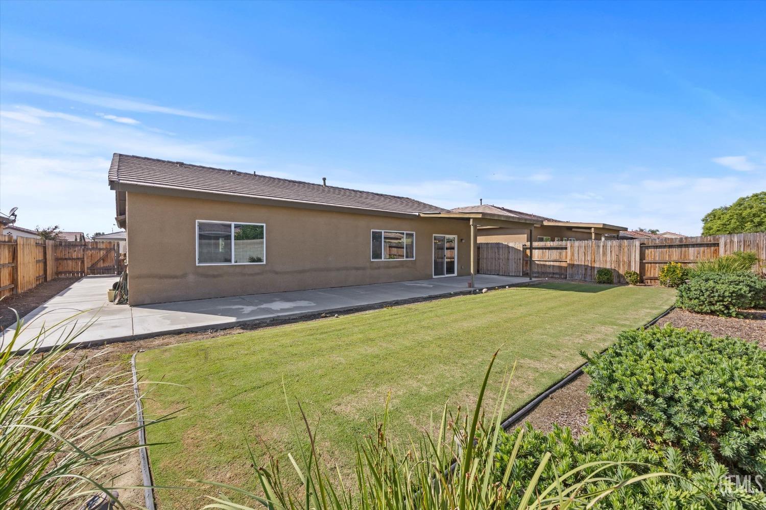 Undisclosed Address Bakersfield, CA 93313 - Photo 28 of 28 a front view of a house with a garden