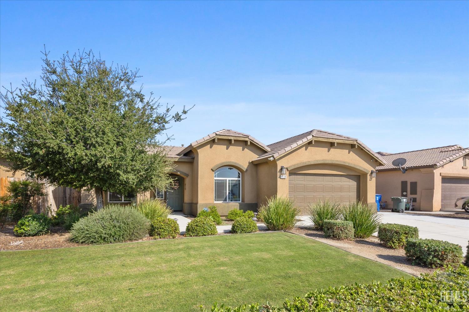 Undisclosed Address Bakersfield, CA 93313 - Photo 3 of 28 a front view of a house with a yard