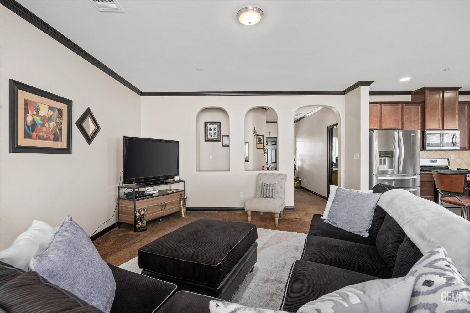 Undisclosed Address Bakersfield, CA 93313 - Photo 8 of 28 a living room with furniture and a flat screen tv