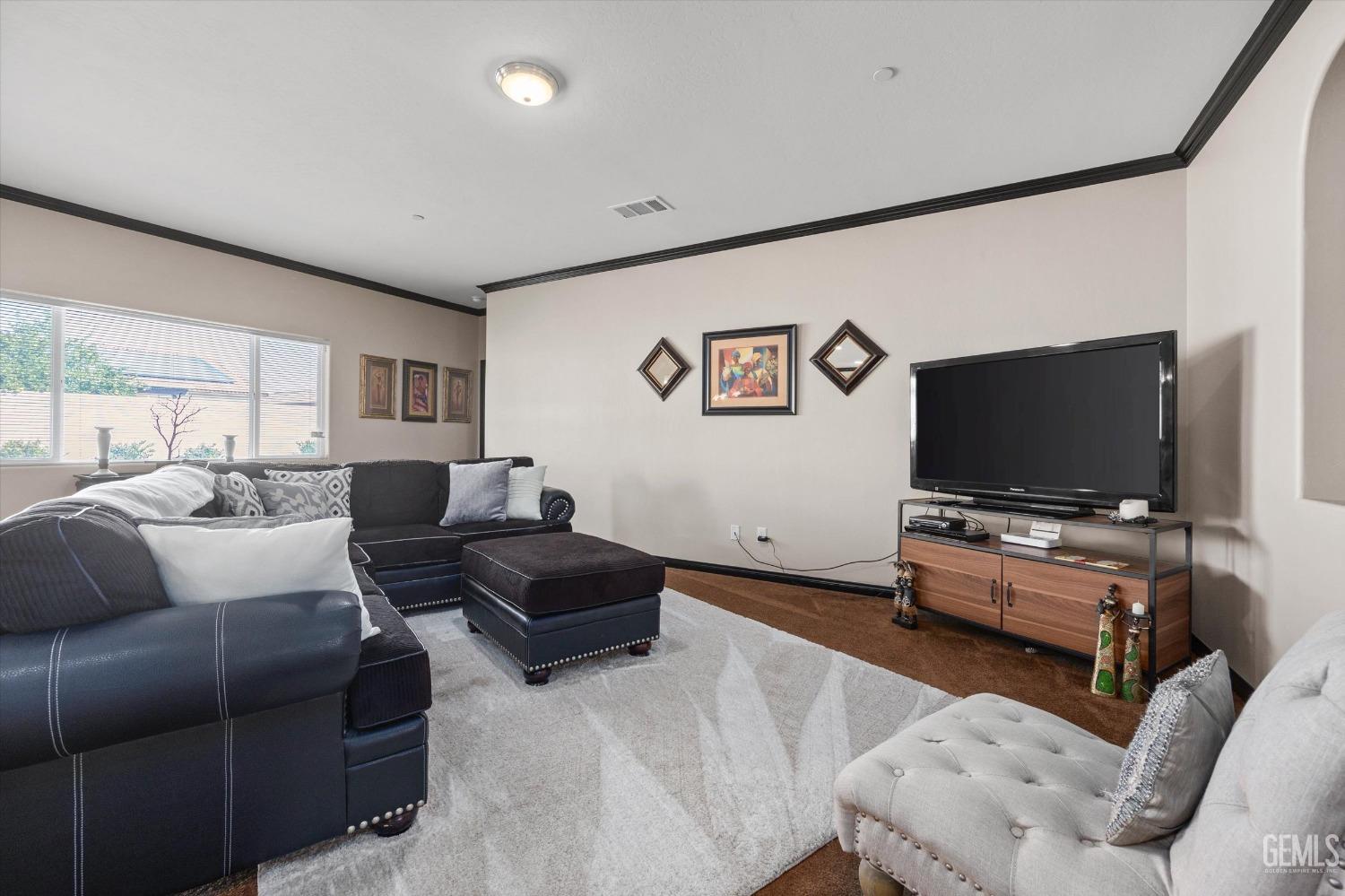Undisclosed Address Bakersfield, CA 93313 - Photo 10 of 28 a living room with furniture and a flat screen tv