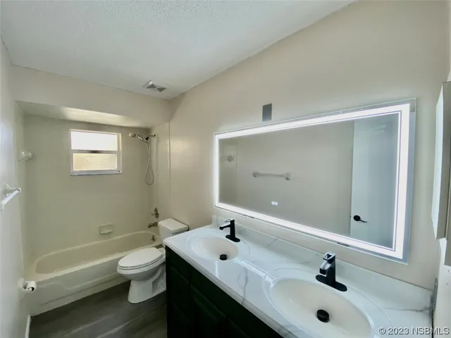 a bathroom with a sink mirror and toilet
