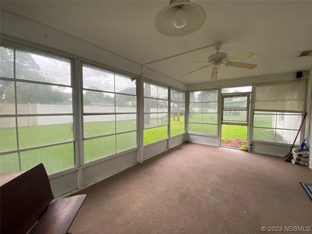 a view of an empty room with a window