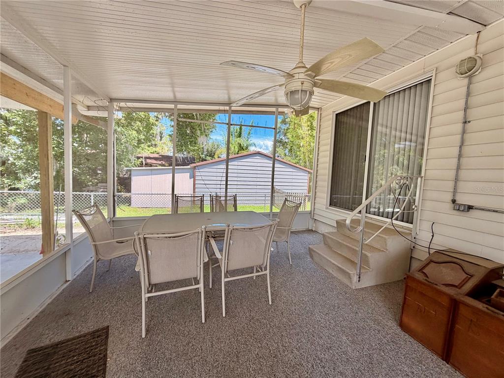 24521 Alligator Road Astor, FL 32102 - Photo 29 of 51 a dining room with furniture a fireplace and large windows