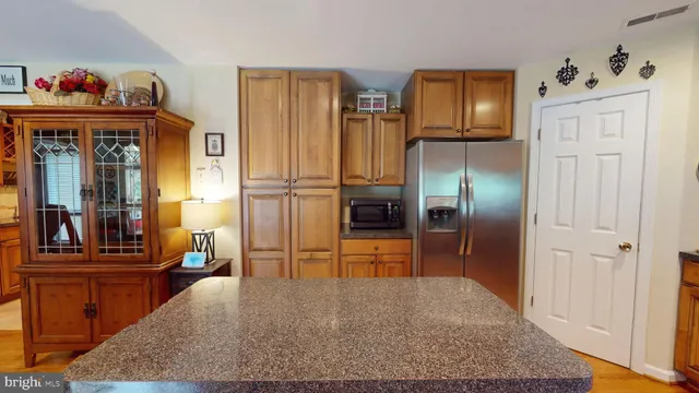 a kitchen with stainless steel appliances granite countertop a stove a sink dishwasher and cabinets with wooden floor