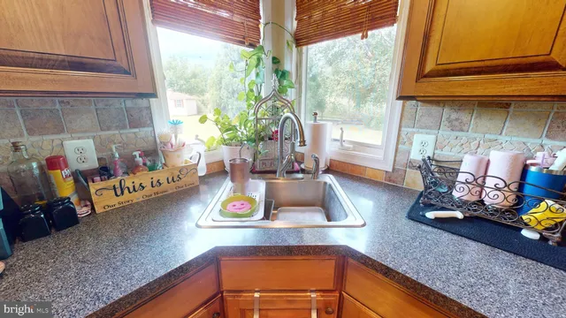 a kitchen with stainless steel appliances granite countertop a sink refrigerator and microwave