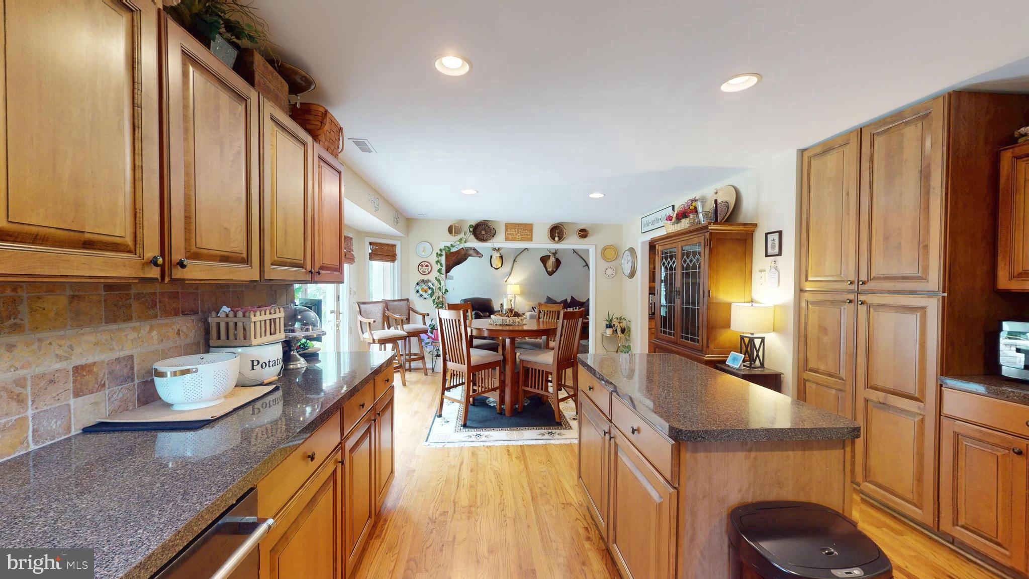 408 Laurens Way Queen Anne, MD 21657 - Photo 21 of 68 a kitchen with stainless steel appliances granite countertop sink refrigerator and stove