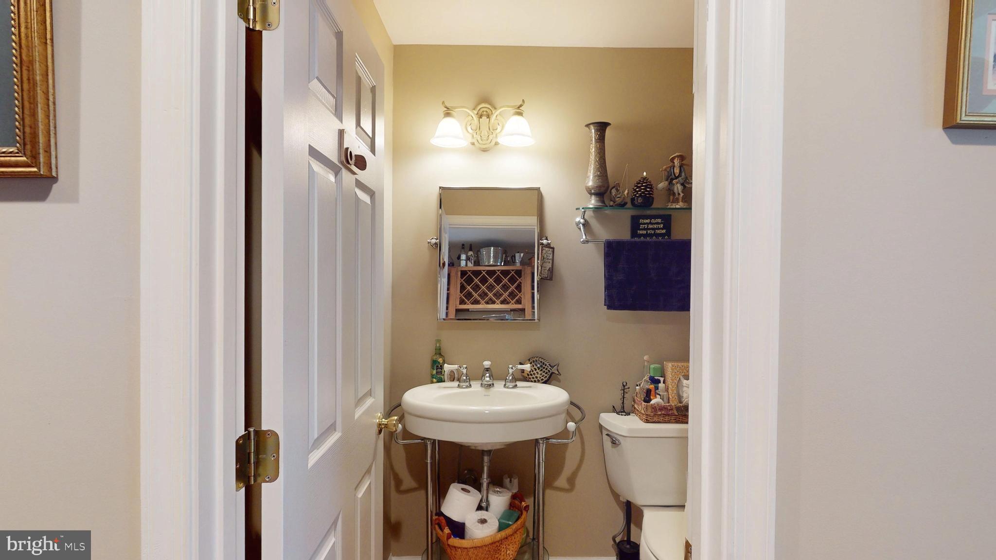 408 Laurens Way Queen Anne, MD 21657 - Photo 28 of 68 a bathroom with a sink and a mirror