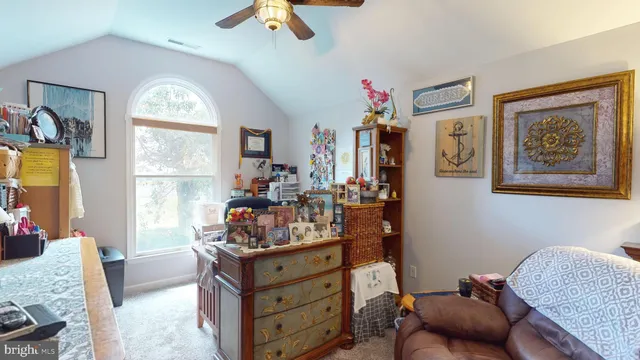 a spacious bedroom with a large bed and a chandelier