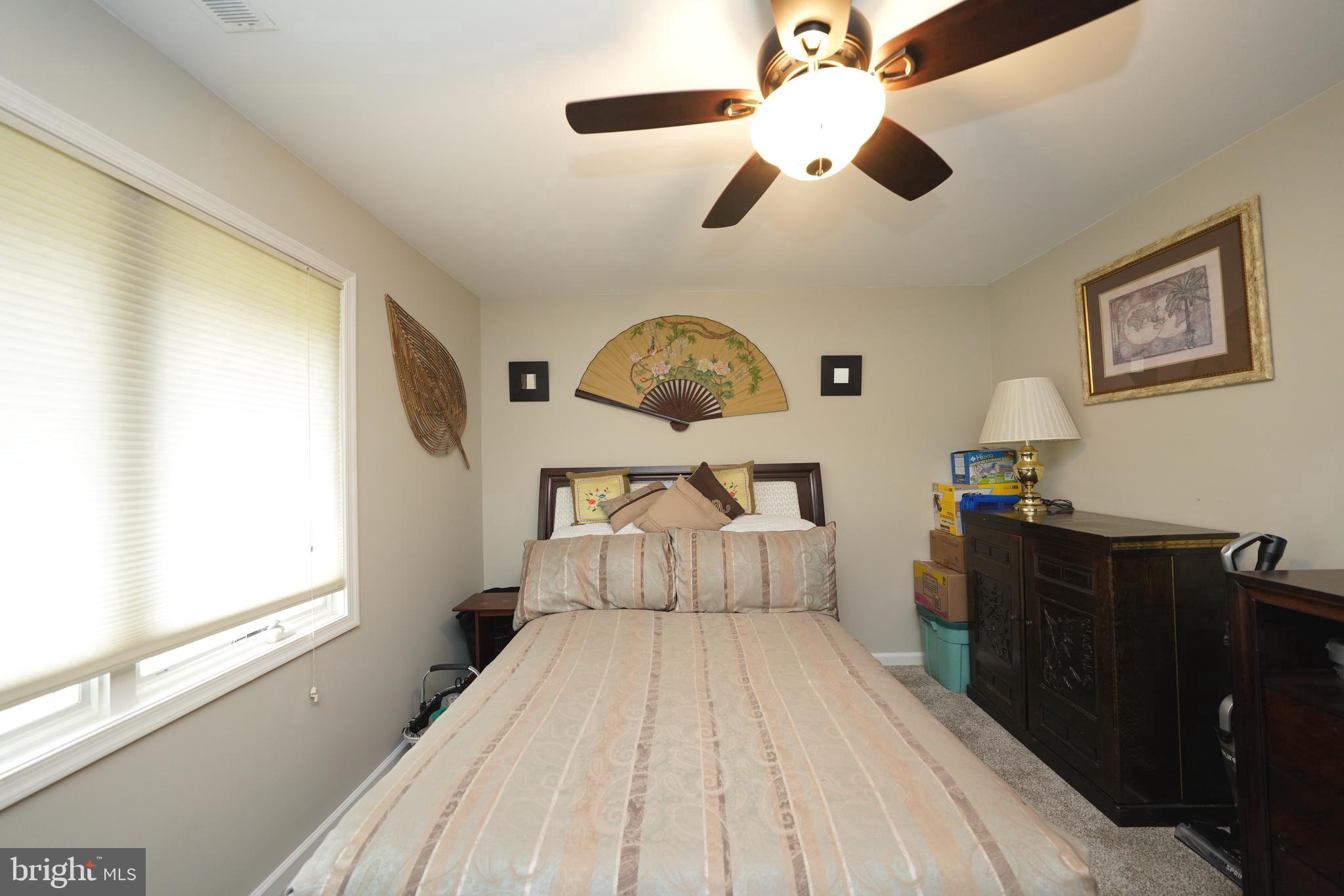 408 Laurens Way Queen Anne, MD 21657 - Photo 44 of 68 a spacious bedroom with a bed and a window