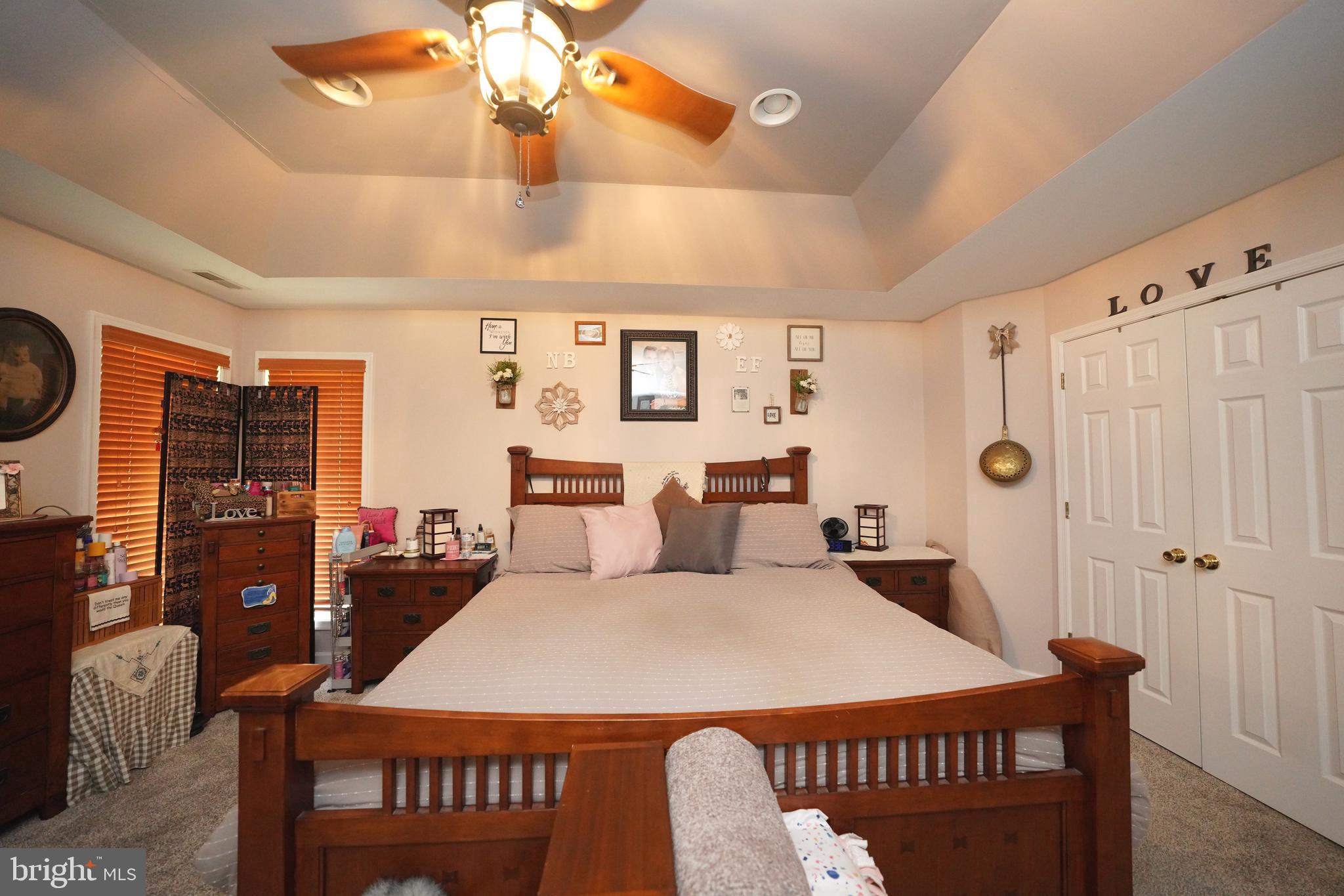 408 Laurens Way Queen Anne, MD 21657 - Photo 46 of 68 a bedroom with a bed and a chandelier