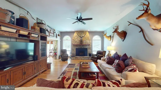 a living room with furniture a flat screen tv and a table