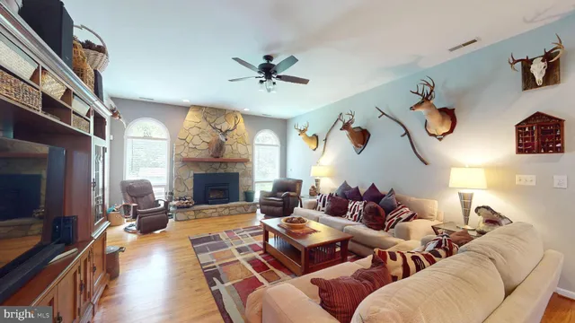 a kitchen with stainless steel appliances granite countertop wooden cabinets a sink dishwasher a refrigerator and a stove