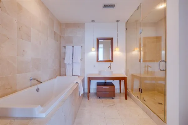 a bathroom with a bathtub and a shower