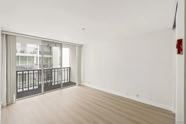 a view of an empty room with wooden floor