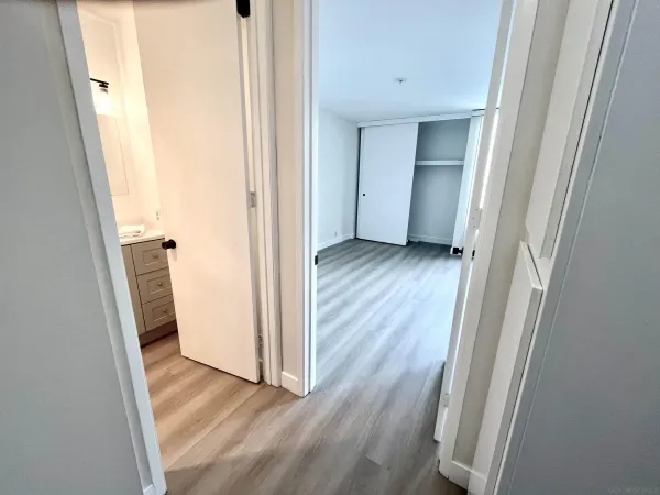 a view of a hallway with wooden floor and a hallway