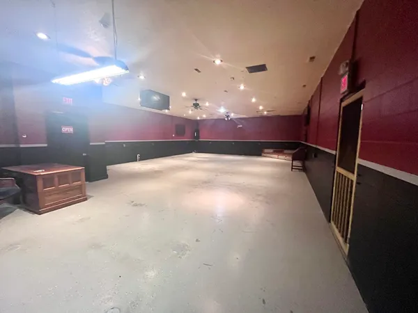 a view of a hallway with a projector and furniture