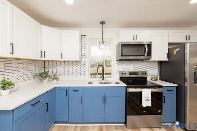 a kitchen with a sink stainless steel appliances and cabinets