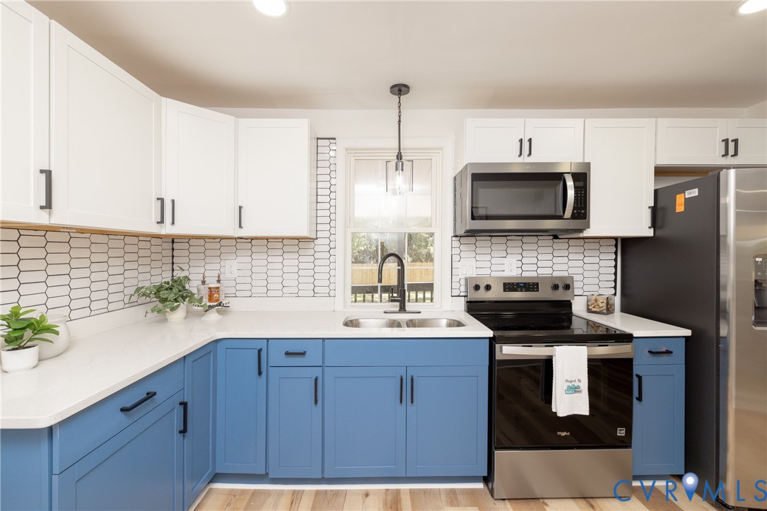 5318 Pine Hill Road Sutherland, VA 23885 - Photo 11 of 50 a kitchen with a sink stainless steel appliances and cabinets