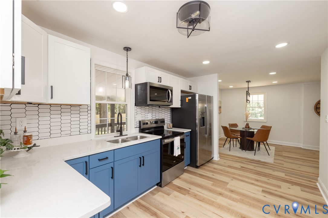 5318 Pine Hill Road Sutherland, VA 23885 - Photo 12 of 50 a kitchen with stainless steel appliances granite countertop a sink dishwasher a stove and a refrigerator with wooden floor