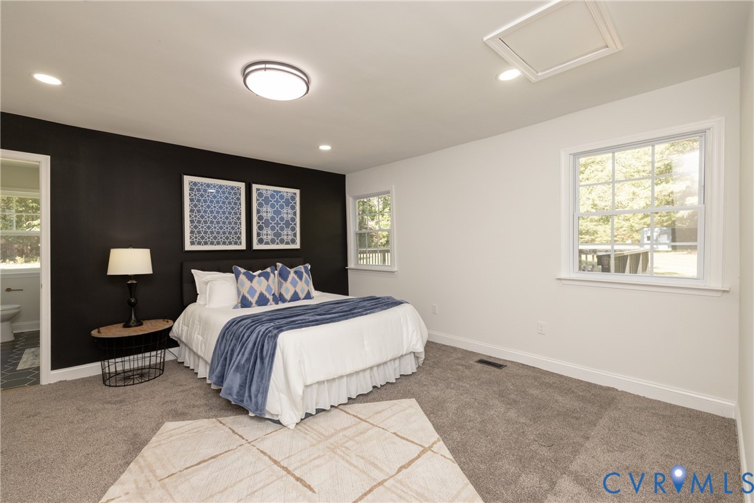 5318 Pine Hill Road Sutherland, VA 23885 - Photo 18 of 50 a bedroom with a large bed and a lamp