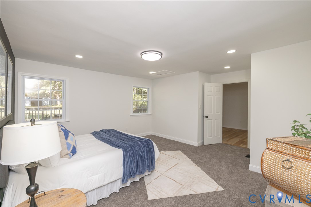 5318 Pine Hill Road Sutherland, VA 23885 - Photo 20 of 50 a spacious bedroom with a bed and a lamp
