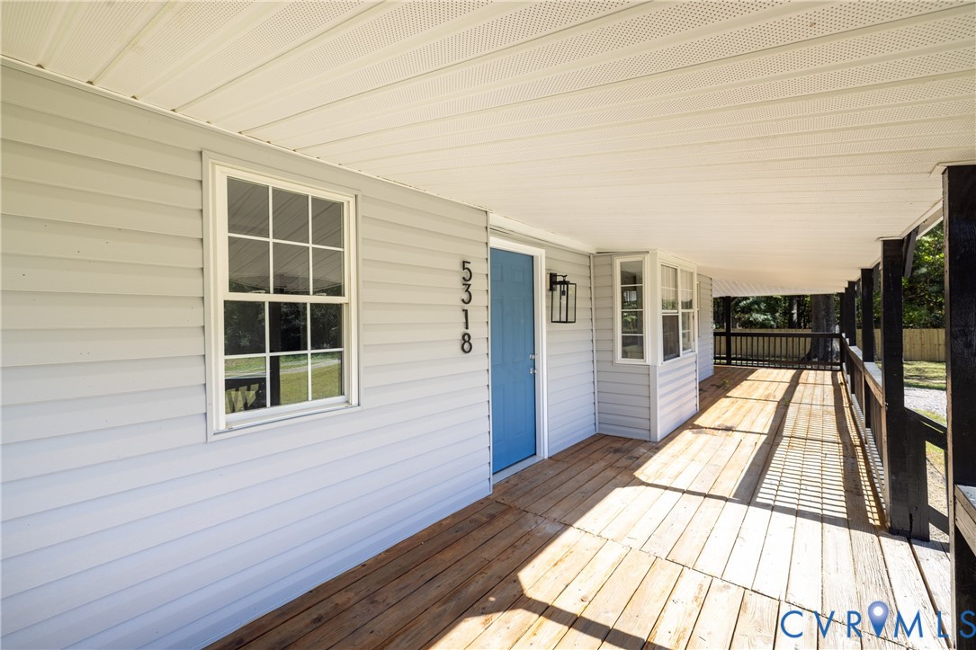 5318 Pine Hill Road Sutherland, VA 23885 - Photo 2 of 50 a view of balcony with wooden floor and floor to ceiling windows