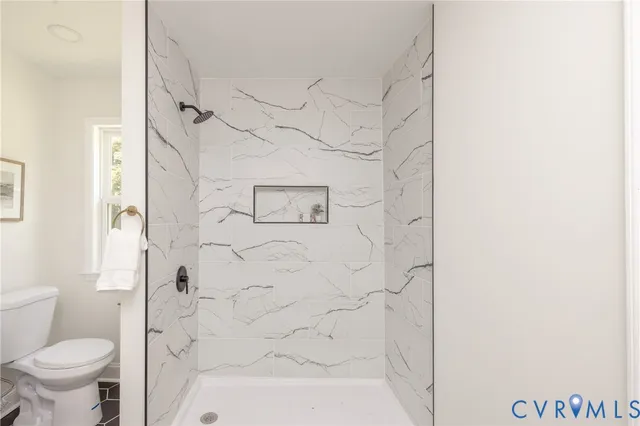 a bathroom with a toilet and shower