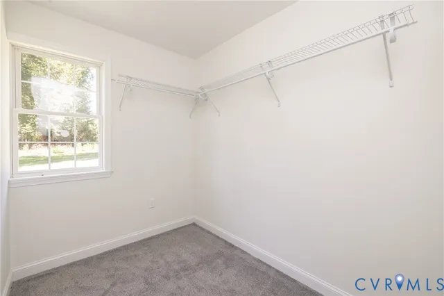 a small space with a window and a fan