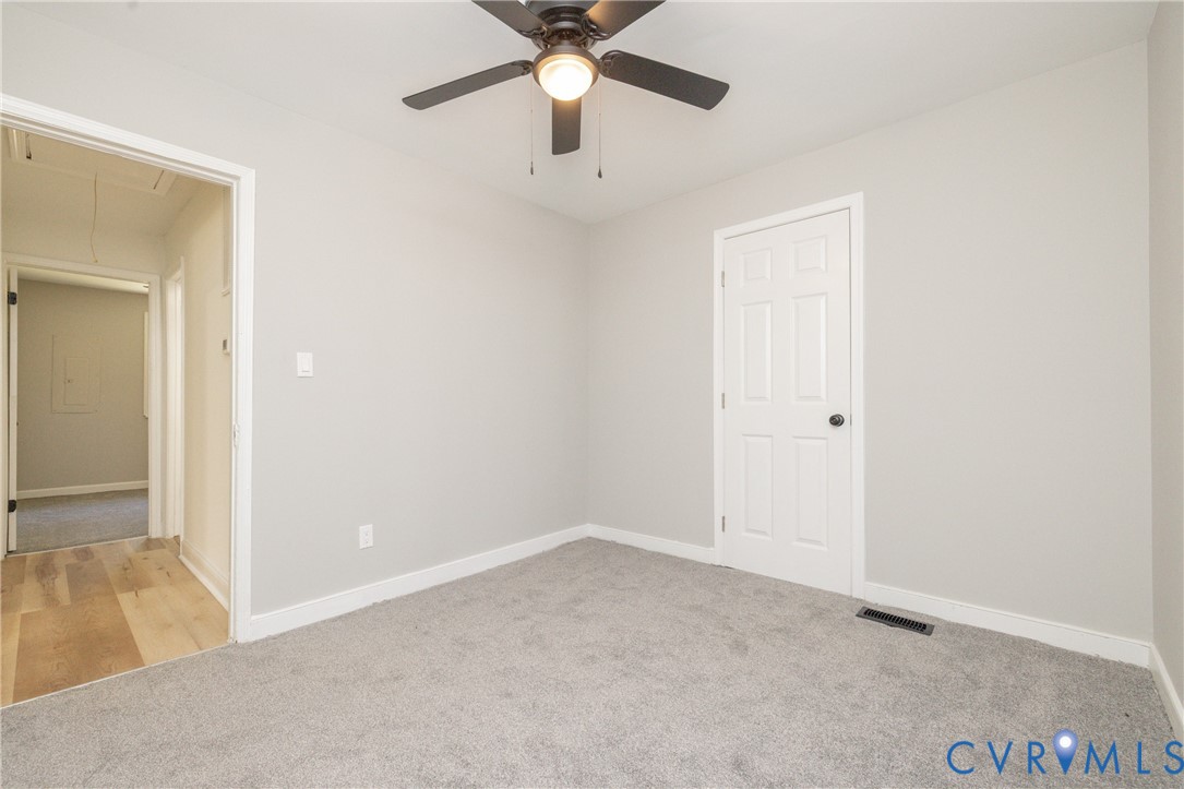 5318 Pine Hill Road Sutherland, VA 23885 - Photo 27 of 50 an empty room with a ceiling fan and a window