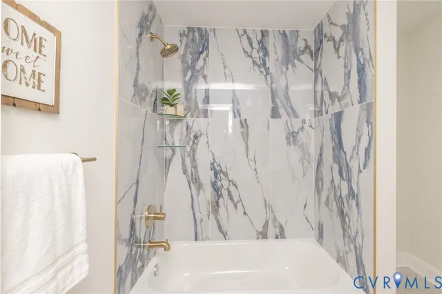 a bathroom with a bathtub and shower