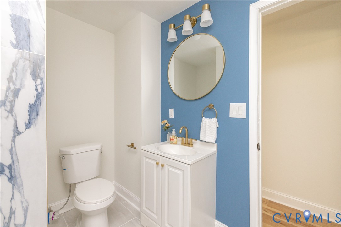 5318 Pine Hill Road Sutherland, VA 23885 - Photo 30 of 50 a bathroom with a toilet a sink and a mirror