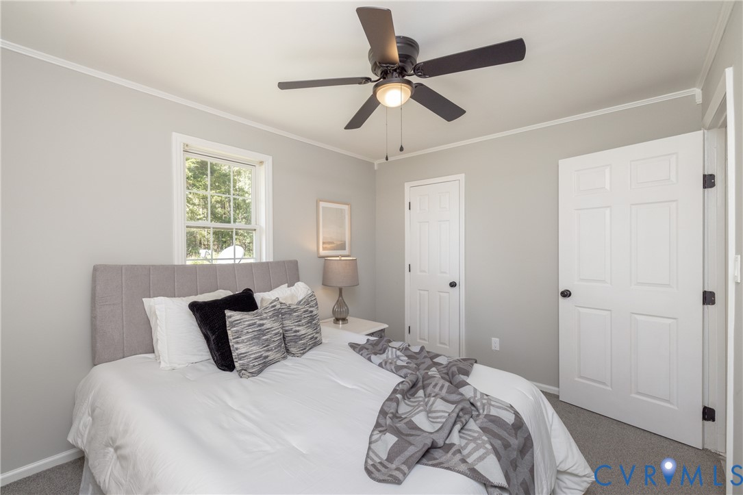 5318 Pine Hill Road Sutherland, VA 23885 - Photo 34 of 50 a bedroom with a large bed and a window