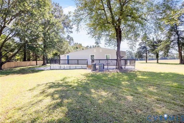 a view of yard with swimming pool and trees