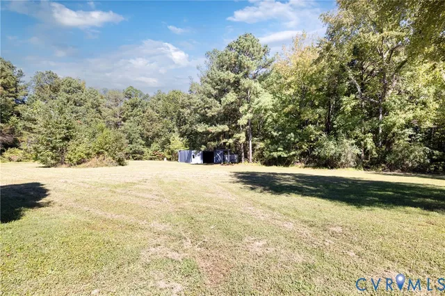 a view of large yard with large trees