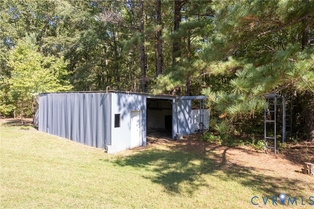 5318 Pine Hill Road Sutherland, VA 23885 - Photo 39 of 50 a backyard of a house with large trees and wooden fence
