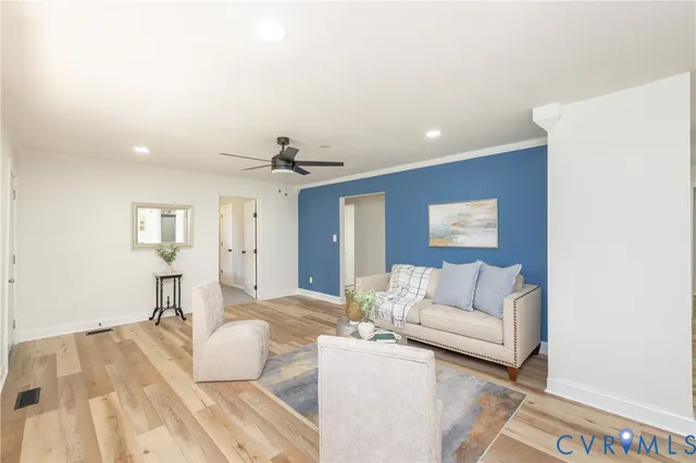 a living room with furniture and a wooden floor
